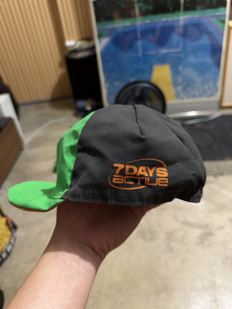 Argon 18 x 7 Days Active Cycling Cap (Category: Caps & Hats) located in Makati City. Submitted by homme.boy.plus (Listing ID 1470484333, Image 2). Description: - Brand: Argon 18 x 7 Days Active collaboration - Color: Charcoal grey and green with orange branding - Material: 65% polyester, 35% cotton (Made in Italy) - Fit: Elasticated back hem for a secure, comfortable fit - Care: Hand wash or gentle machine wash inside out at 30°C.