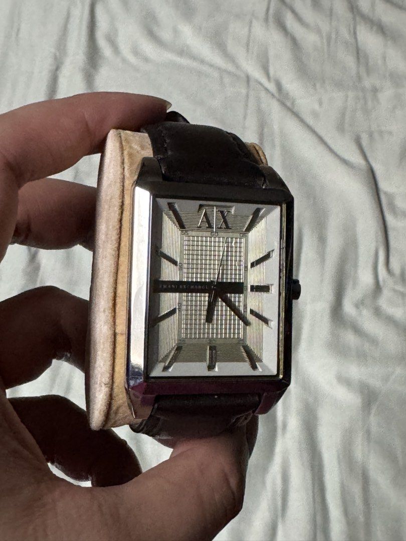 Armani Exchange Rectangular Dial Leather Strap Watch (Category: Women's Watches) located in Manila. Submitted by seangoart (Listing ID 1470488735, Image 2). Description: - Brand: Armani Exchange - Movement: Quartz - Dial: Rectangular with a unique checkered pattern and silver-tone markers - Strap: Dark brown genuine leather with signed buckle - Style: Classic dress watch, versatile for casual or formal wear - Condition: Excellent.