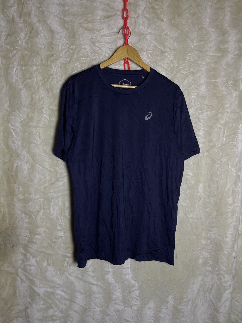 Asics Navy Blue Athletic T-Shirt Size L (Category: Activewear) located in Molave. Submitted by charlesthrifter (Listing ID 1470358439, Image 1). Description: - Brand: Asics - Color: Navy blue with white logo on chest - Size: L - Material: Polyester blend - Design: Short sleeves, crew neck - Origin: Made in Indonesia - Condition: Excellent, ready to wear.