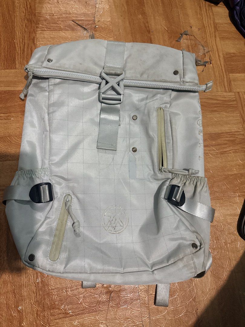 ASUS laptop backpack with multiple pockets (Category: Backpacks) located in Trece Martires City. Submitted by garciaclaudinejoy (Listing ID 1470376307, Image 1). Description: - Color: Light grey ISSUE: MADUMI, need labhan - Closure: Secure front buckle - Storage: Multiple zippered compartments and side water bottle pockets - Comfort: Padded shoulder straps with adjustable buckles and D-rings - Design: Geometric quilted stitching on the back panel