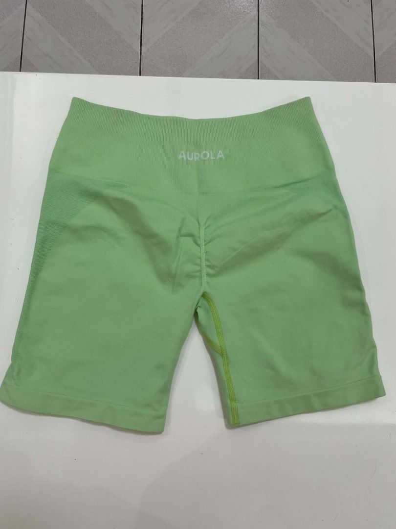 Aurola Seamless Workout Shorts Green (Category: Activewear) located in Quezon City. Submitted by revivingstuff (Listing ID 1470358345, Image 2). Description: - Brand: Aurola - Color: Bright green - Waistband: Ribbed high waistband for extra support - Design: Scrunch bum and subtle side contour shading - Material: Stretchy, lightweight, breathable, and seamless fabric - Versatility: Ideal for gym workouts, running, or casual errands - Styling: Eas