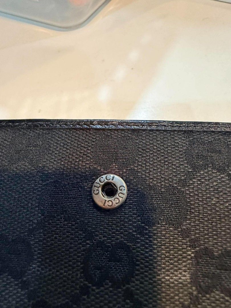 Auth Gucci GG Canvas Bamboo Tri-fold Wallet Black (Category: Luxury Bags & Wallets) located in Midsayap. Submitted by purse_gedo (Listing ID 1470472735, Image 3). Description: - Authentic Gucci tri-fold wallet - Material: Black GG canvas with durable leather trim - Design: Iconic front bamboo closure with branded snap button hardware - Interior: Multiple card slots and a convenient coin compartment - Condition/Details: Compact size for daily use,