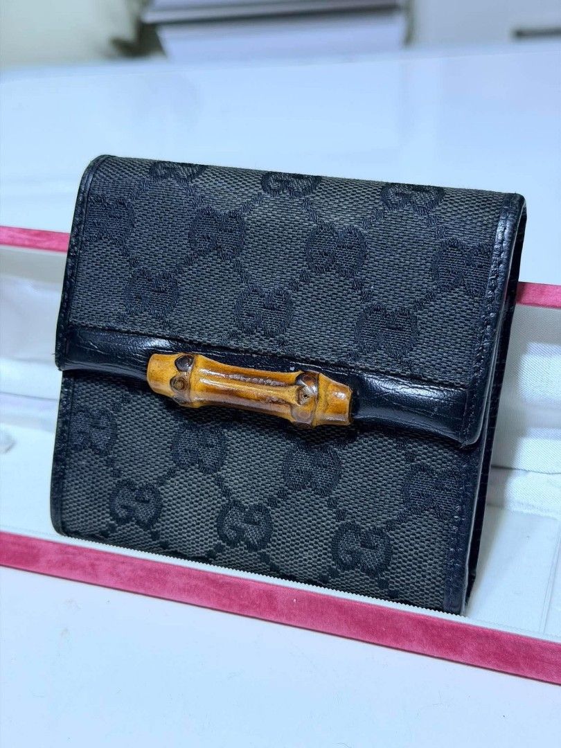 Auth Gucci GG Canvas Bamboo Tri-fold Wallet Black (Category: Luxury Bags & Wallets) located in Midsayap. Submitted by purse_gedo (Listing ID 1470472735, Image 1). Description: - Authentic Gucci tri-fold wallet - Material: Black GG canvas with durable leather trim - Design: Iconic front bamboo closure with branded snap button hardware - Interior: Multiple card slots and a convenient coin compartment - Condition/Details: Compact size for daily use,