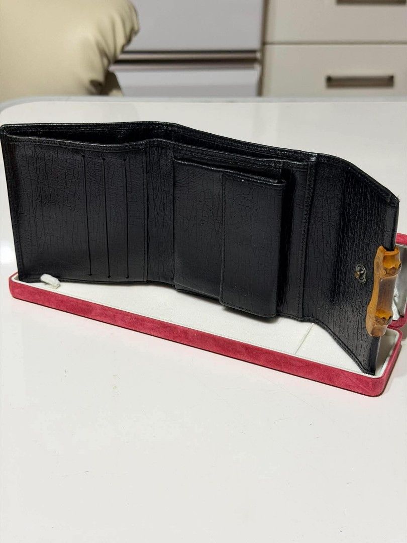 Auth Gucci GG Canvas Bamboo Tri-fold Wallet Black (Category: Luxury Bags & Wallets) located in Midsayap. Submitted by purse_gedo (Listing ID 1470472735, Image 2). Description: - Authentic Gucci tri-fold wallet - Material: Black GG canvas with durable leather trim - Design: Iconic front bamboo closure with branded snap button hardware - Interior: Multiple card slots and a convenient coin compartment - Condition/Details: Compact size for daily use,