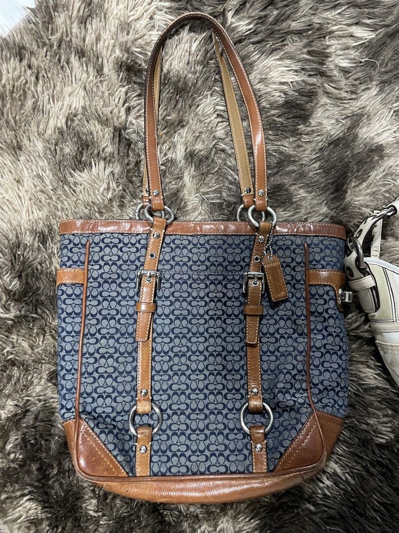 Authentic Coach Signature Tote and Hobo Bag Bundle (Category: Luxury Bags & Wallets) located in Calapan. Submitted by lucasthrifts (Listing ID 1470492949, Image 2). Description: - Authentic Coach 2-Bag Bundle - Bag 1: blue signature denim tote with tan leather trim, dual straps, buckle accents, and leather hangtag - Bag 2: Small white and cream signature C canvas hobo shoulder bag with stylish chain strap detail - Condition: Normal signs of previ