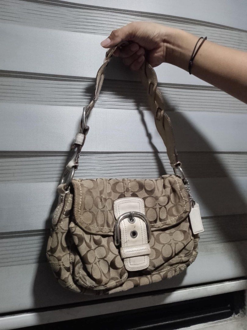 Authentic Coach Soho Double Flap Canvas Shoulder Bag (Category: Luxury Bags & Wallets) located in Alaminos. Submitted by maribelsyyyy_ (Listing ID 1470473504, Image 1). Description: - Authentic Coach signature C jacquard shoulder bag (Khaki/Brown with White leather trim) - Classic early 2000s Y2K aesthetic with front buckle flap closure - Stylish and comfortable braided leather shoulder strap with silver-tone hardware - Interior lined with smooth