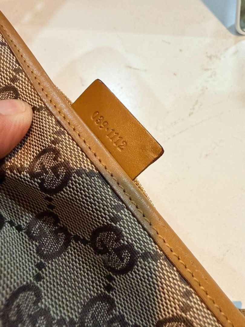 Authentic Gucci GG Canvas Pouch™️ (Category: Luxury Bags & Wallets) located in Midsayap. Submitted by purse_gedo (Listing ID 1470472416, Image 3). Description: - Authentic Gucci monogram canvas pouch in beige and brown - Premium tan leather trim with secure zipper closure - Clean fabric-lined interior - Interior leather tag with 'Gucci Made in Italy' stamp - Serial number: 039-1112 - Stylish and functional designer accessory.