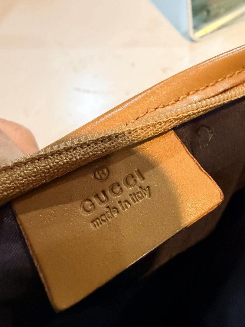 Authentic Gucci GG Canvas Pouch™️ (Category: Luxury Bags & Wallets) located in Midsayap. Submitted by purse_gedo (Listing ID 1470472416, Image 2). Description: - Authentic Gucci monogram canvas pouch in beige and brown - Premium tan leather trim with secure zipper closure - Clean fabric-lined interior - Interior leather tag with 'Gucci Made in Italy' stamp - Serial number: 039-1112 - Stylish and functional designer accessory.