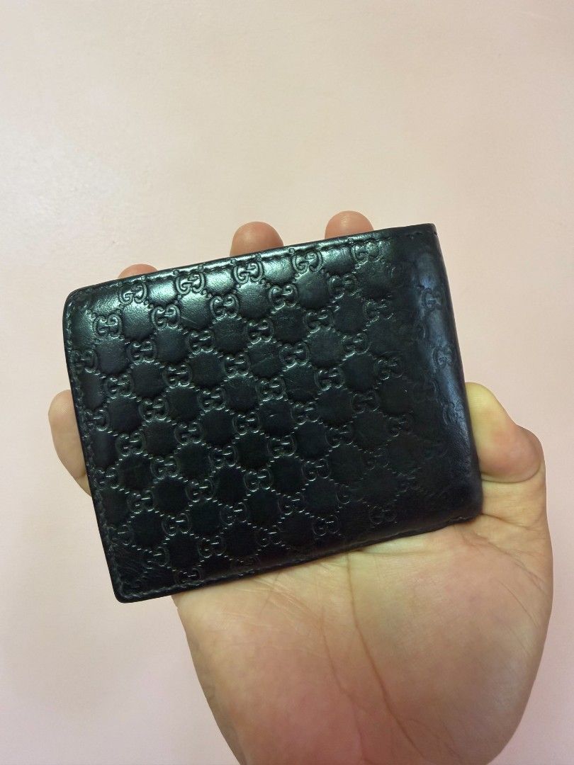 Authentic Gucci micro guccissima bifold (Category: Luxury Bags & Wallets) located in Puerto Princesa. Submitted by lotsstuff (Listing ID 1470382972, Image 3). Description: Black GG embossed leather Includes None Origin Italy Date/Authenticity Code: 260987-525040 Measurements: 5" L x 3.75" H Interior Pockets: Six card slots, two flat pockets and one long bill compartment Closure/Opening: Bi-fold closure Interior Lining: Leather Condition: GOOD. Th