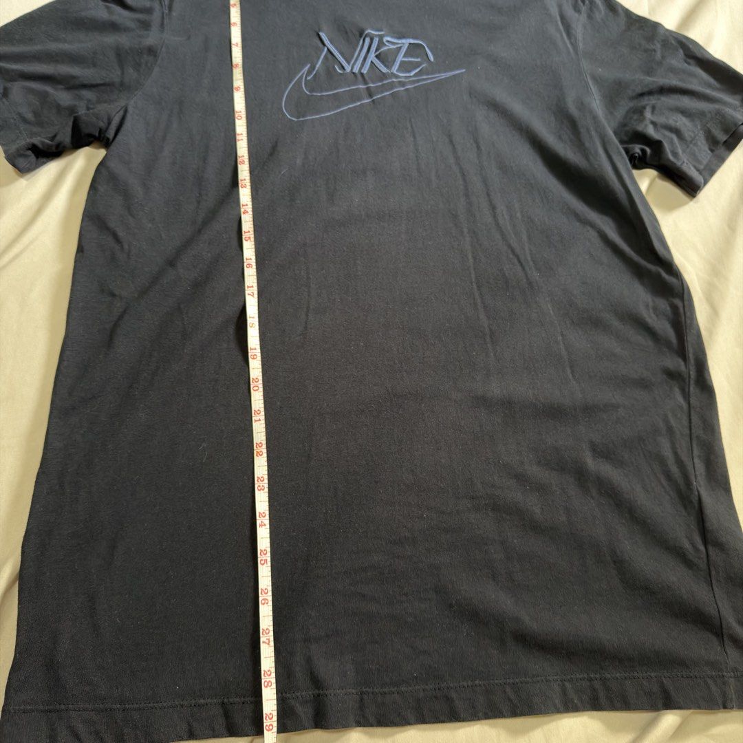 Authentic Nike T-Shirt with Embroidered Logo (Category: Shirts) located in Taytay. Submitted by melaniemaep (Listing ID 1470389543, Image 2). Description: - Brand: Nike - Color: Dark blue with stylized blue embroidered chest logo - Material: Comfortable cotton fabric - Size/Measurements: Measured flat approx. 29" length x 20" chest - Style: Casual short sleeve crewneck, perfect everyday streetwear - Versatility: Easy to style with denim jeans or 