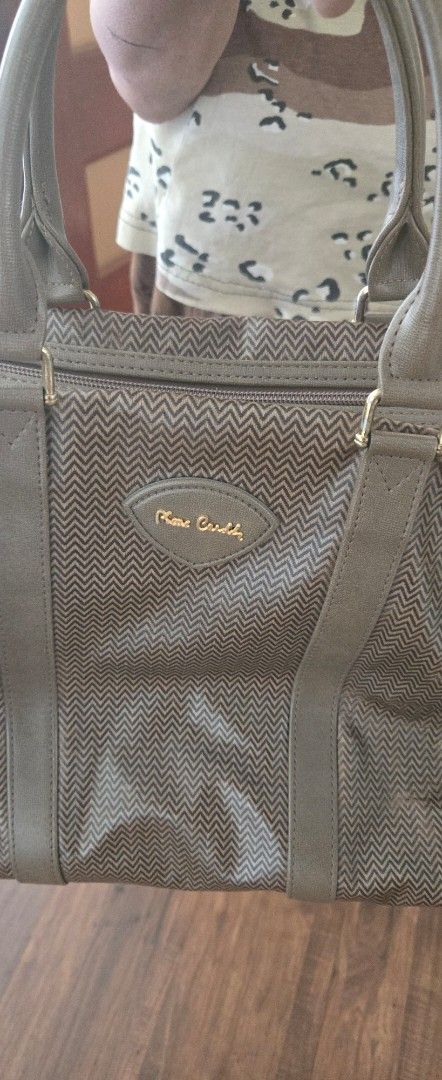 Authentic Pierre Cardin Large Boston Bag (Category: Luxury Bags & Wallets) located in Quezon City. Submitted by PreLovedByMrsAL (Listing ID 1470373270, Image 3). Description: - Authentic Pierre Cardin handbag in brown - Stylish zigzag chevron pattern with solid brown trim - Structured shape with front logo plaque - Roomy interior, ideal for daily essentials or travel - Condition: Excellent / Preloved (ready to use) bought from Japan photos as pos