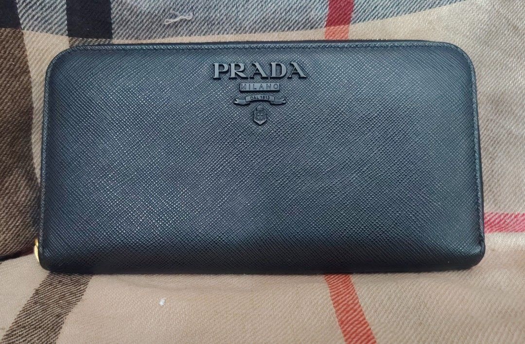 authentic prada saffiano leather long wallet (Category: Wallets & Card holders) located in Iloilo. Submitted by l3orloloy (Listing ID 1470395310, Image 1). Description: authentic prada saffiano leather long wallet verygood condi issue leather puller 3k.