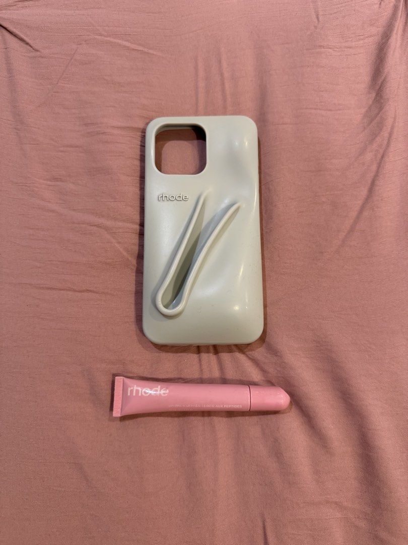 authentic rhode lip phone case iphone 15 pro max (free peptide lip) (Category: Cases & Sleeves) located in Manila. Submitted by _____car0usell (Listing ID 1470497939, Image 2). Description: - Authentic Rhode Lip Case in Gray + Rhode Peptide Lip Tint in Ribbon (free) - for iPhone 15 pro max - bought brand new and shipped from the US. I believe its around 4.5k php for both the case and lip tint - lip case is in like-new condition - minor flaw on th