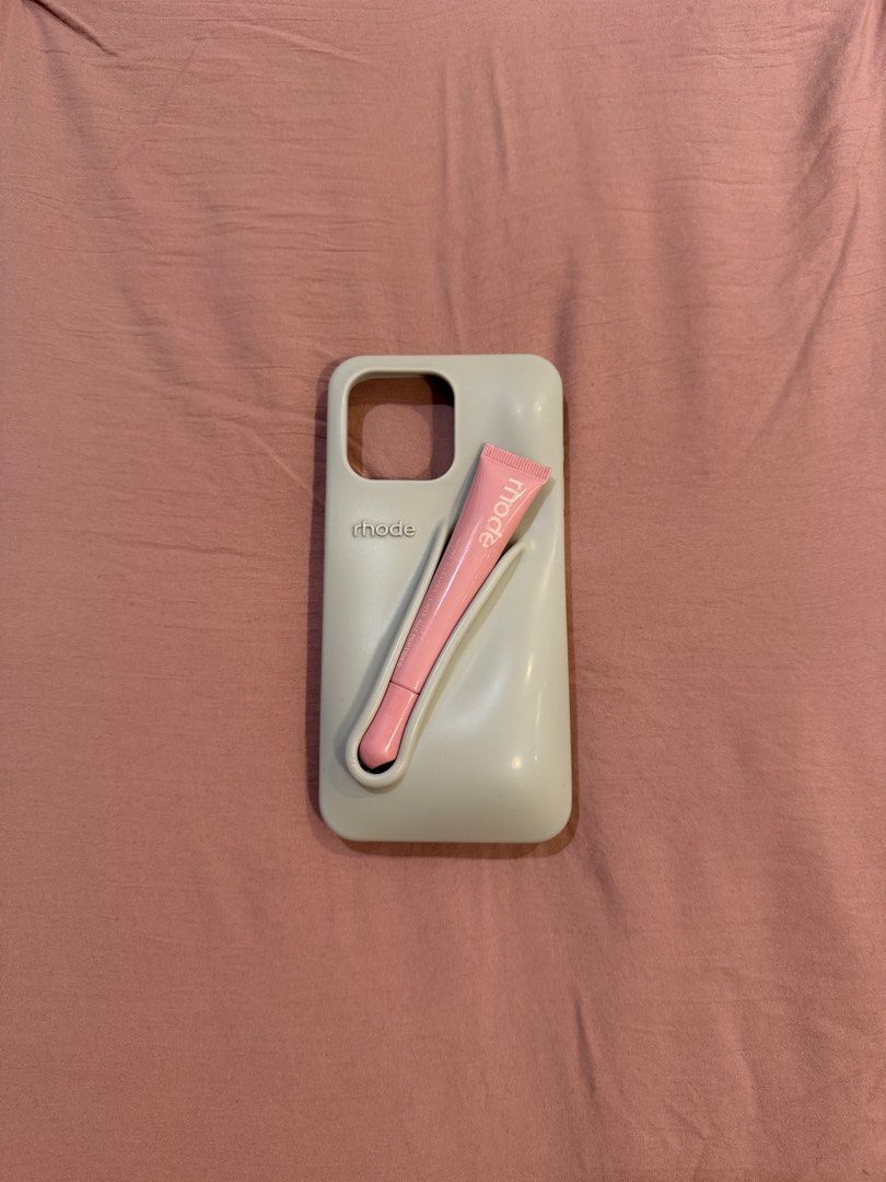 authentic rhode lip phone case iphone 15 pro max (free peptide lip) (Category: Cases & Sleeves) located in Manila. Submitted by _____car0usell (Listing ID 1470497939, Image 1). Description: - Authentic Rhode Lip Case in Gray + Rhode Peptide Lip Tint in Ribbon (free) - for iPhone 15 pro max - bought brand new and shipped from the US. I believe its around 4.5k php for both the case and lip tint - lip case is in like-new condition - minor flaw on th