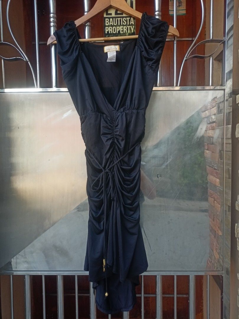 Baby Phat Black Ruched Dress Medium (Category: Dresses) located in Cavite. Submitted by ronniel0943882 (Listing ID 1470409381, Image 1). Description: - Brand: Baby Phat - Color: Black - Size: Medium - Material: 92% polyester, 8% spandex (stretchable and comfortable) - Design: Deep V-neckline with gathered front ruching - Details: Adjustable string ties with chic gold hardware beads - Condition: Good, with a small stitched repair on the shoulder f