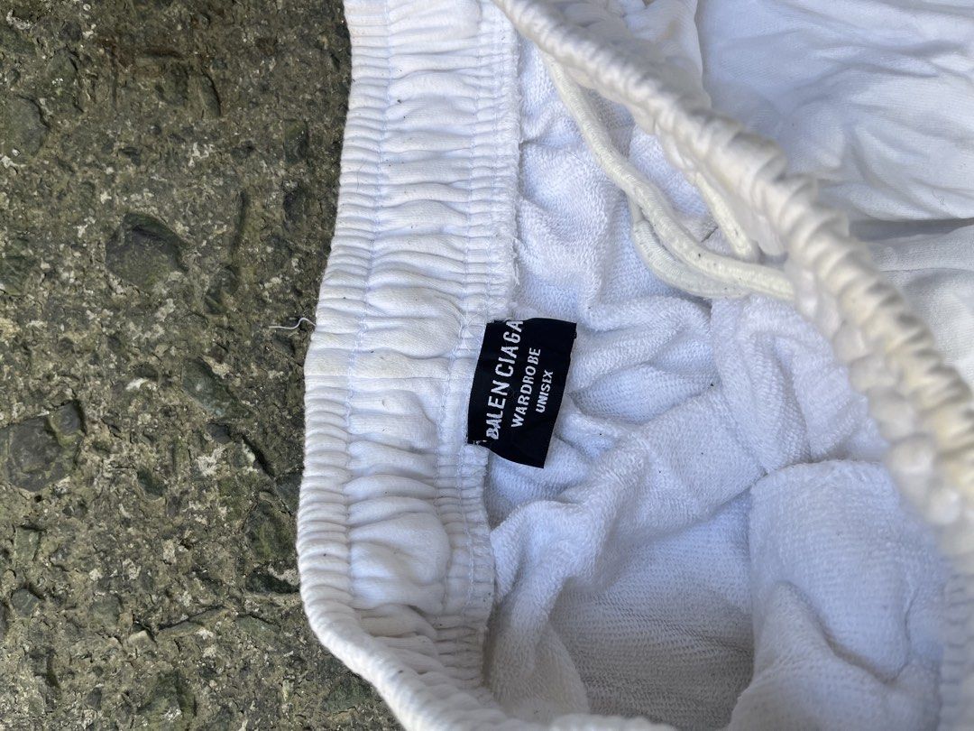 Balenciaga Multi Logo Printed Sweatpants White Size L (Category: Joggers) located in Manila. Submitted by shanaaa.collects (Listing ID 1470394929, Image 2). Description: - Brand: Balenciaga - Color: White - Material: Heavy cotton fleece - Design: All-over brand logo prints on legs - Details: Elastic waistband with adjustable drawstring - Origin: Made in Portugal - Size: L (tag attached) - Condition: Shows some light stains from wear - Style: Perf