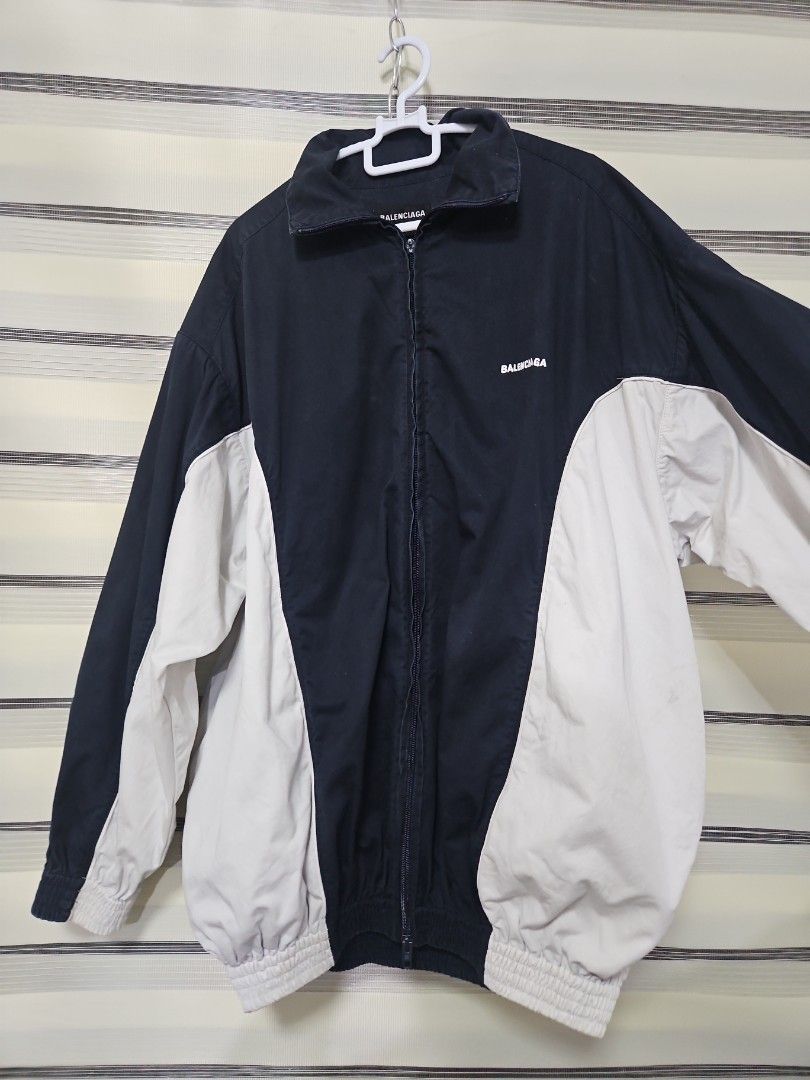 Balenciaga Navy and White Zip Jacket Size 46 (Category: Luxury Apparel) located in Santa Maria. Submitted by rommelmateo (Listing ID 1470531688, Image 2). Description: - Authentic Balenciaga zip-up jacket - Stylish navy and white color-block design with contrast side panels - Relaxed fit featuring elasticated cuffs and hem - High collar with full front zipper closure - Subtle printed logo on the chest - Size: 46 (Tag attached) - Origin: Made in S