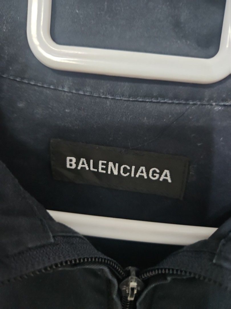 Balenciaga Navy and White Zip Jacket Size 46 (Category: Luxury Apparel) located in Santa Maria. Submitted by rommelmateo (Listing ID 1470531688, Image 3). Description: - Authentic Balenciaga zip-up jacket - Stylish navy and white color-block design with contrast side panels - Relaxed fit featuring elasticated cuffs and hem - High collar with full front zipper closure - Subtle printed logo on the chest - Size: 46 (Tag attached) - Origin: Made in S
