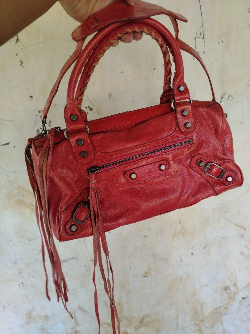 BALENCIAGA TWIGGY (Category: Luxury Bags & Wallets) located in Don Carlos. Submitted by thriftnidodong_23 (Listing ID 1470430022, Image 1). Description: leather Balenciaga "The Twiggy" 2-way motorcycle bag from the Nicolas Ghesquière era, featuring braided top handles, a detachable shoulder strap, and signature tassel fringe..