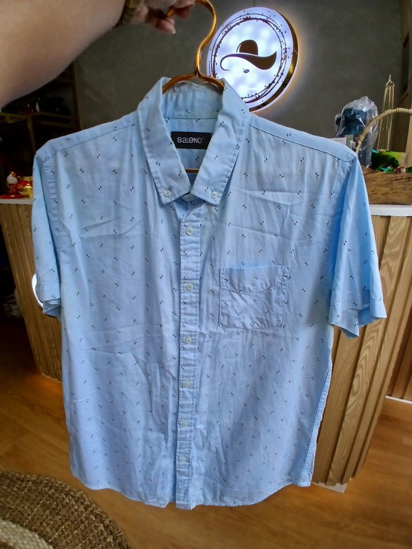 Baleno Light Blue Button-Up Short Sleeve Shirt with Pattern (Category: Tshirts & Polo Shirts ) located in Manila. Submitted by charlene_selda29 (Listing ID 1470385819, Image 1). Description: - Brand: Baleno - Color: Light blue with all-over small print - Style: Short sleeve button-up with standard collar - Features: Left chest pocket, front button closure - Condition/Vibe: Casual wear, perfect and easy to style for warm days.