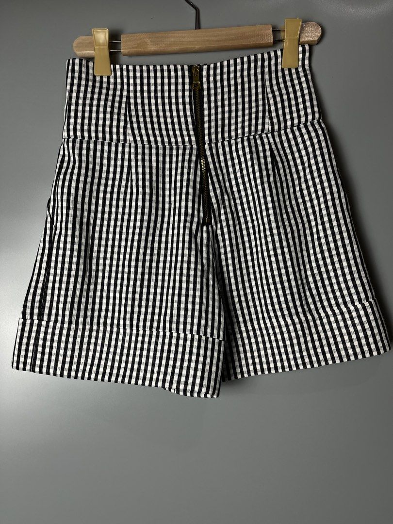 Balmain Black and White Gingham High-Waisted Shorts (Category: Shorts) located in Dagupan City. Submitted by loves2thrifth (Listing ID 1470420100, Image 2). Description: - Brand: Balmain - Pattern: Black and white gingham - Fit: High-waist with structured pleats and cuffed hems - Details: Double-breasted gold embossed front buttons and exposed gold-tone back zipper with branded pull tab - Condition: Clean fabric, crisp pattern - Environment: From