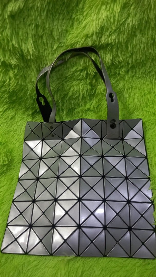 Bao Bao Issey Miyake Lucent Tote Bag Silver (Category: Tote Bags) located in Manila. Submitted by twinklelyn03 (Listing ID 1470416550, Image 3). Description: - Brand: Bao Bao Issey Miyake - Color: Metallic Silver - Design: Iconic geometric triangular panel design - Features: Adjustable top snap-button handles, inner zip pocket with branded pull tab, and durable fabric lining - Practicality: Extremely lightweight construction and folds completely 