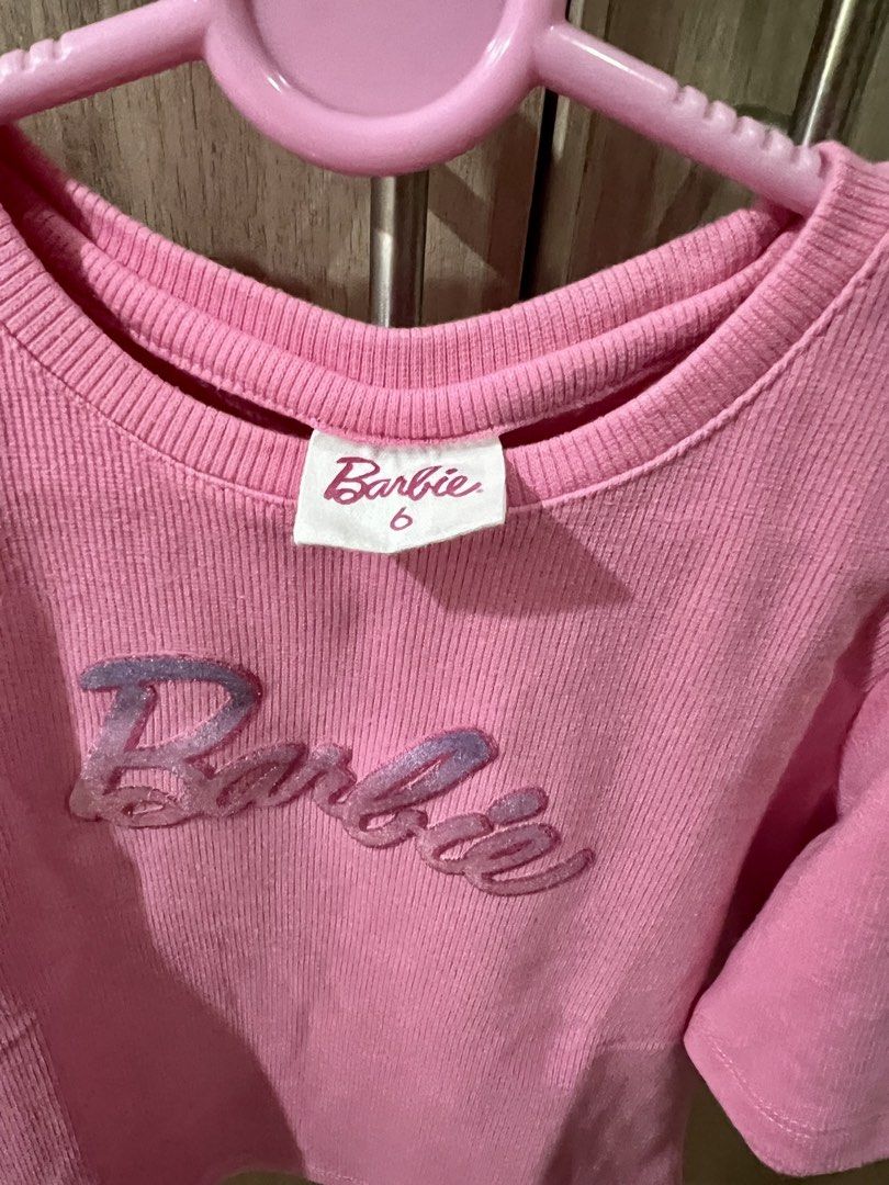 Barbie Pink Ribbed Top (Category: Babies & Kids Fashion) located in Makati City. Submitted by tinkrbelle (Listing ID 1470397645, Image 3). Description: - Official Barbie pink ribbed t-shirt, size 6 - Cold shoulder sleeve design - Sparkly purple embroidered Barbie logo on the chest - Small logo tag near the bottom hem - Great everyday outfit for young fans *payment thru gcash *delivery fee c/o buyer.