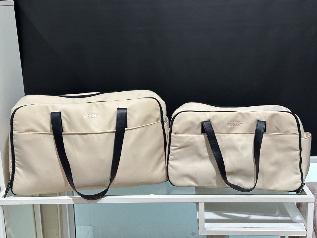 Bash Travel Duffle Bag Set with Pouch (Category: Shoulder Bags) located in Mandaluyong City. Submitted by shopkcllanillo (Listing ID 1470556582, Image 1). Description: GET BOTH FOR ₱2,500.00 - Brand/Model: Matching Bash travel set - Colorway: Cream beige with stylish black leather straps - Set Inclusions: Large duffle and mini duffle, and a small matching pouch - Interior Features: Mesh zippered compartments for easy organization - Condition: Zip