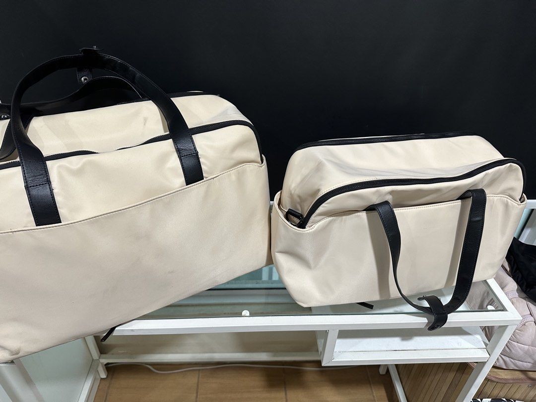 Bash Travel Duffle Bag Set with Pouch (Category: Shoulder Bags) located in Mandaluyong City. Submitted by shopkcllanillo (Listing ID 1470556582, Image 3). Description: GET BOTH FOR ₱2,500.00 - Brand/Model: Matching Bash travel set - Colorway: Cream beige with stylish black leather straps - Set Inclusions: Large duffle and mini duffle, and a small matching pouch - Interior Features: Mesh zippered compartments for easy organization - Condition: Zip