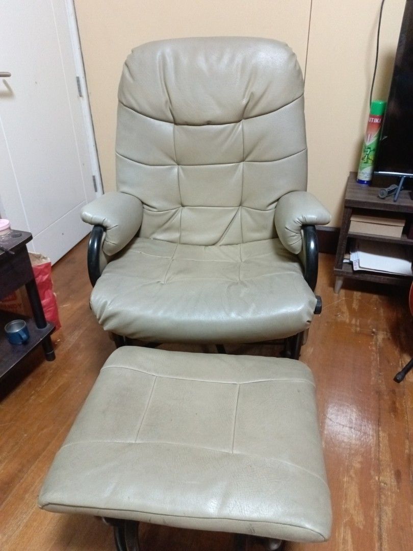 beige glider armchair with matching ottoman (Category: Chairs) located in Paranaque City. Submitted by pinkdenxel (Listing ID 1470355059, Image 1). Description: - Comfy beige leather armchair and matching footstool set - Built on smooth rocking glider bases for ultimate relaxation - Thick cushioning on back, seat, and arms - Stylish dark wood curved side handles - Shows minor signs of everyday wear - Great addition to any living room or nursery.