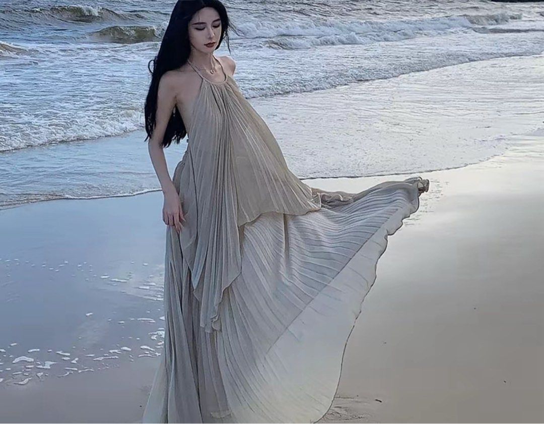 Beige pleated halter neck open back maxi dress (Category: Dresses) located in Makati City. Submitted by lemoneyeddd (Listing ID 1470501609, Image 1). Description: - Color: Elegant beige - Material: Flowy chiffon that moves beautifully in the wind - Style: Halter neck, open back with tie straps, floor-length with a gorgeous flare - Design: All-over pleats - Condition: Worn once for a beach trip, freshly washed, and ready to wear - Mode of Payment: