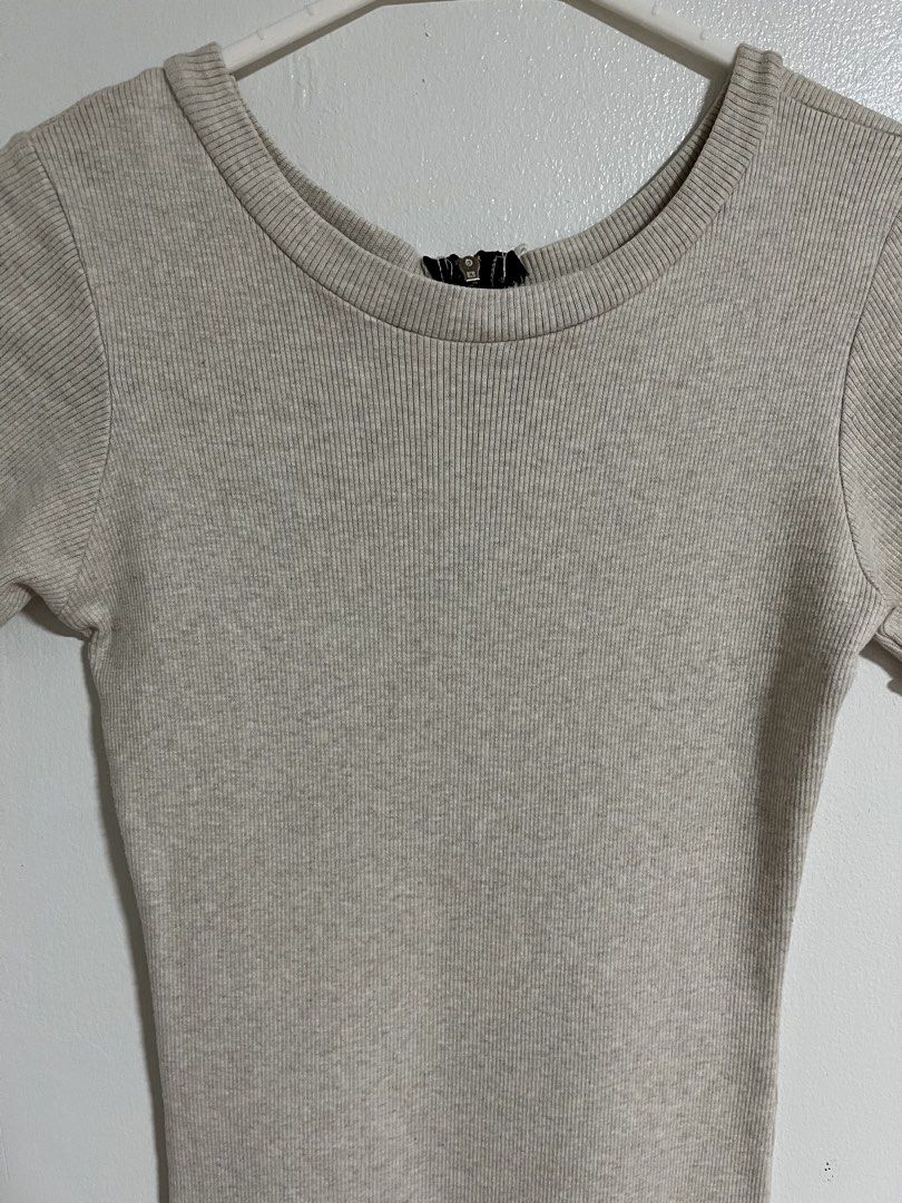 Beige ribbed knit mini dress with half zip (Category: Dresses) located in Cabuyao City. Submitted by rdtrmt (Listing ID 1470476955, Image 2). Description: - Style: Bodycon fit mini dress - Color: Beige - Details: Ribbed knit fabric, short sleeves with lettuce hem, back half-zip closure - Fit: Super stretchy - Condition: Clean and still in good condition .