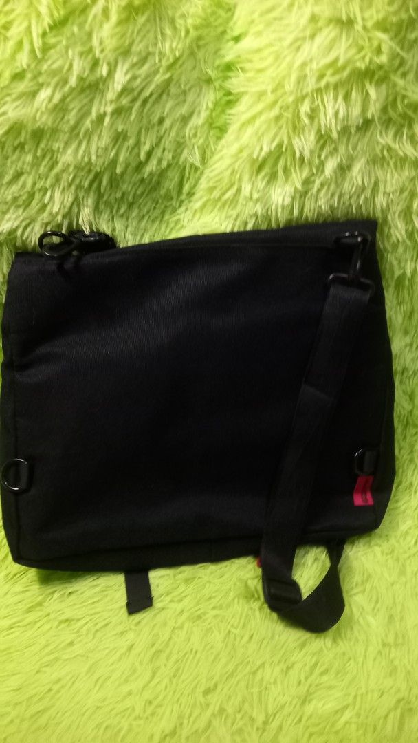 Bilibili Goods Black Messenger Bag (Category: Sling Bags) located in Manila. Submitted by twinklelyn03 (Listing ID 1470416907, Image 2). Description: - Brand: Bilibili Goods - Color: Classic black with red brand tag - Material: Sturdy, durable canvas - Features: Adjustable shoulder strap, secure front flap with buckle closures, main zip compartment, interior slip pockets, and exterior D-rings for attachments see photos for details pm sa sure buye