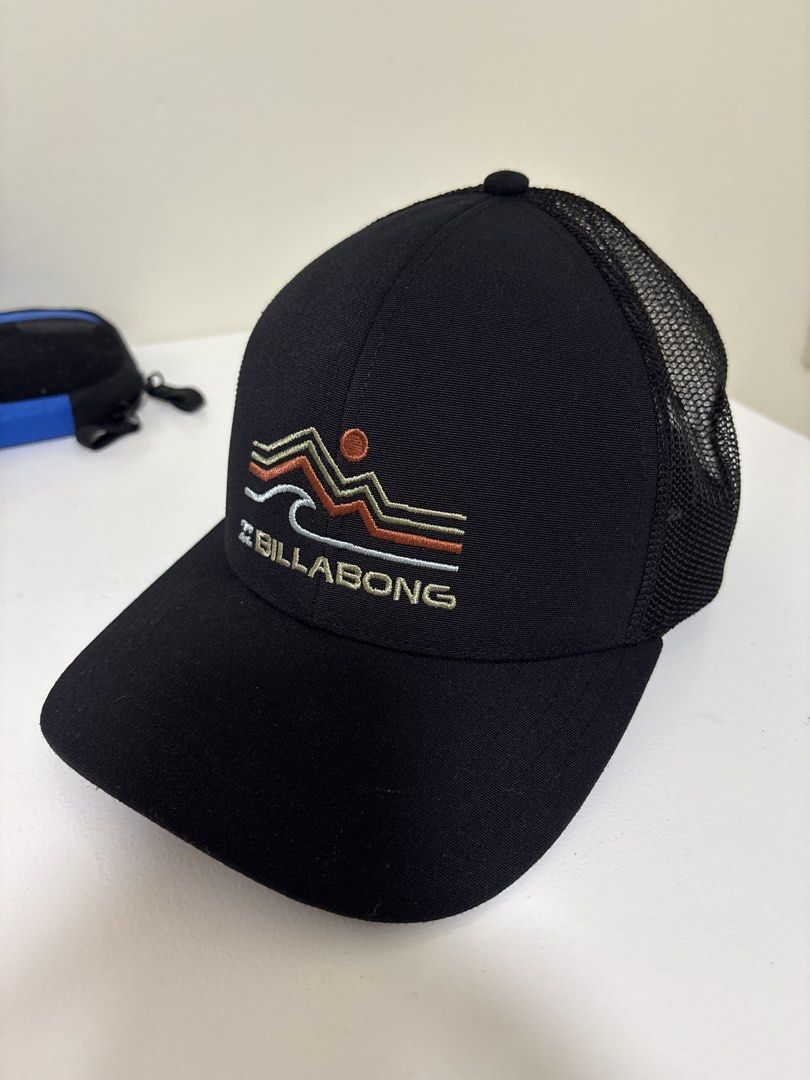 Billabong Trucker Hat Black Wave Mountain Logo (Category: Caps & Hats) located in Brookes Point. Submitted by tntkicks (Listing ID 1470359822, Image 1). Description: - Brand: Billabong - Color: Classic Black - Design: Embroidered mountain, sun, and wave front graphic - Style: Trucker hat with breathable mesh back panels - Fit: Adjustable plastic snapback closure - Condition: Clean crown and brim, with interior branded tags and 'Made in Vietnam' l