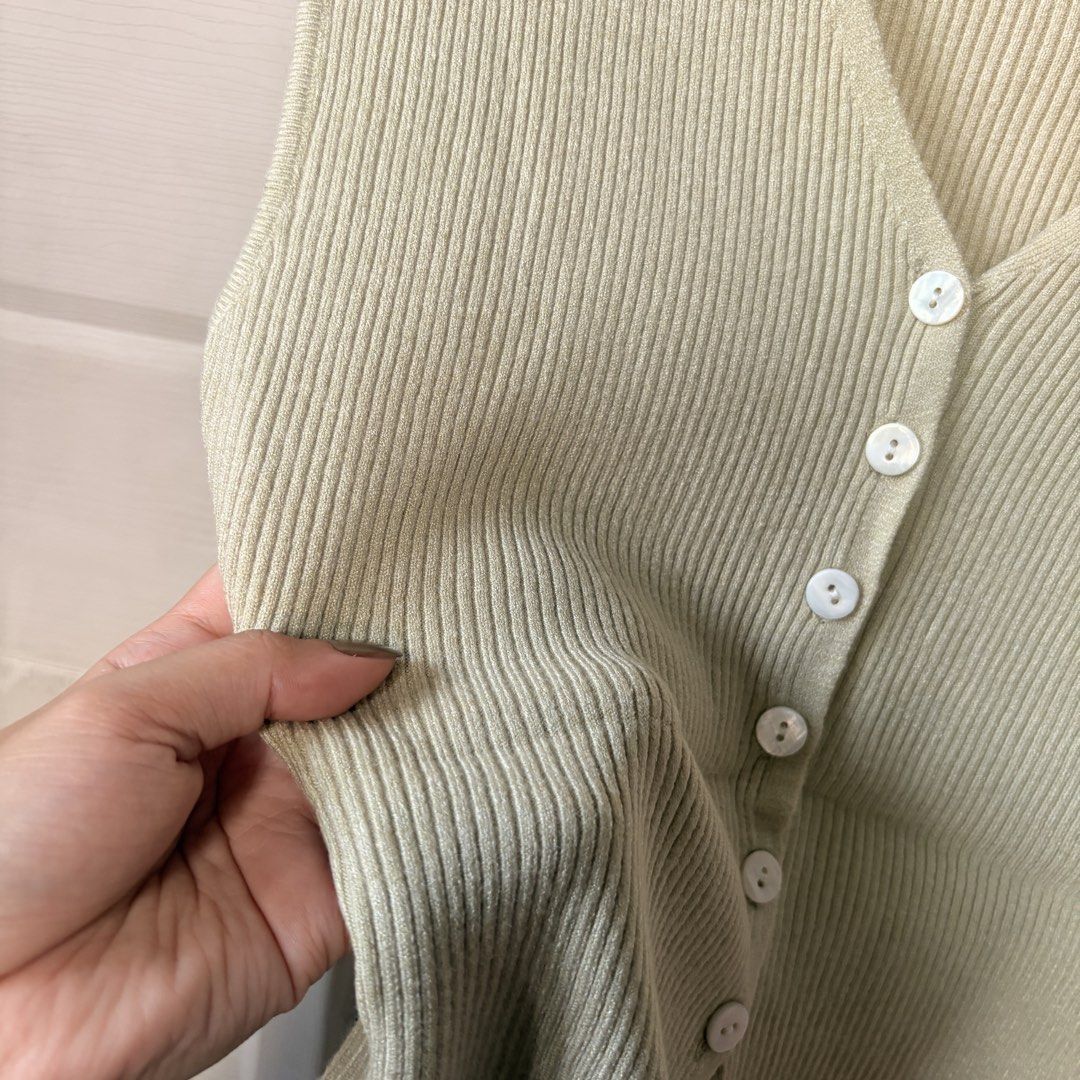 BKK Ribbed Sleeveless Top (Category: Sleeveless) located in Makati City. Submitted by iu__00 (Listing ID 1470444966, Image 2). Description: - Brand: ONE-K -Size: Small to Med - Color: Avocado green - Material: Stretchy ribbed knit fabric - Design: V-neckline with white buttons, cap sleeves, plain back - Fit: Fitted and flattering.