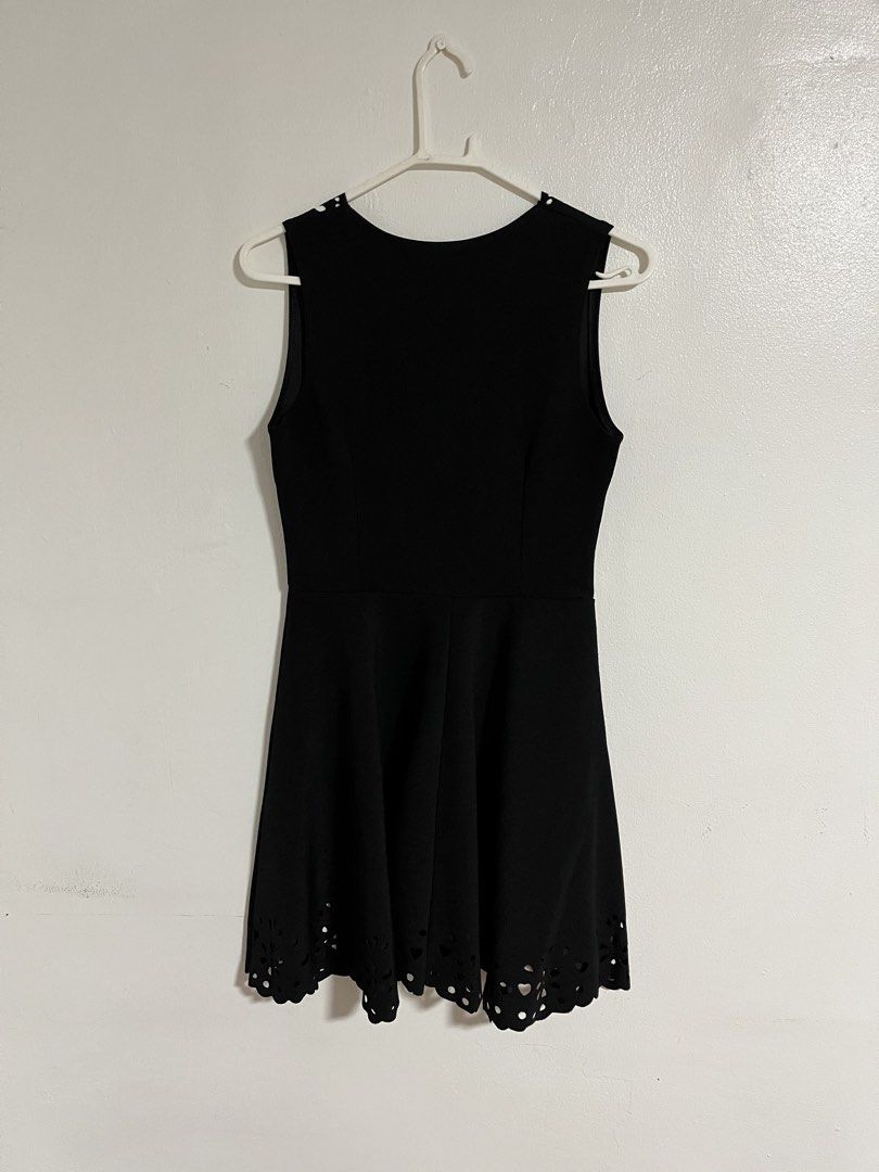 Black A-line Sleeveless Dress (Category: Dresses) located in Cabuyao City. Submitted by rdtrmt (Listing ID 1470440274, Image 3). Description: - Color: Black - Design: Sleeveless with a fitted bodice, waist seam, and flared skirt - Details: Elegant laser-cut scalloped pattern along the V-neckline and bottom hem - Back: Simple scoop back design - Versatility: Perfect for casual outings or dinners - Condition: still in good condition.