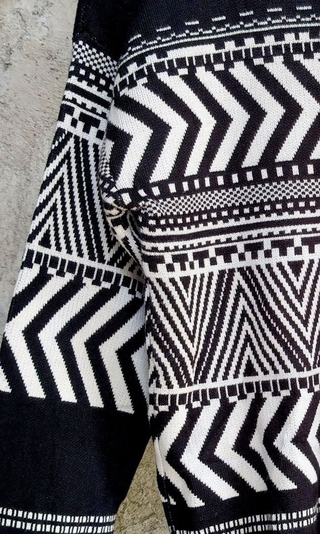 Black and White Geometric Pattern Turtleneck Sweater (Category: Longsleeves) located in Makati City. Submitted by thriftersmakati (Listing ID 1470385806, Image 3). Description: - Color: Black and white - Design: Bold geometric chevron and tribal-inspired patterns across chest and sleeves - Neckline: High folded collar / turtleneck style - Sleeves & Hem: Long sleeves with ribbed cuffs and hem - Material: Cozy knit fabric - Condition: Excellent.