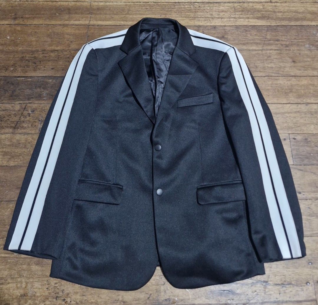 Black Blazer Jacket White Striped Sleeves Two Button (Category: Coats, Jackets and Outerwear) located in Manila. Submitted by blackstarharpoon (Listing ID 1470525022, Image 1). Description: - Color: Classic Black with distinctive white stripes on sleeves - Style: Smart casual blazer with a sporty track-jacket twist - Features: Lapel collar, two front buttons, lower flap pockets, and a chest welt pocket - Interior: Fully lined for comfort - Constr