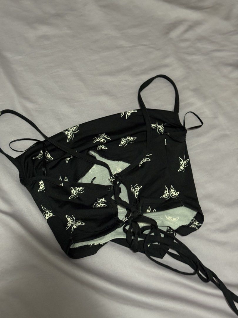 Black Butterfly Print Halter Crop Top Size S (Category: Sleeveless) located in Angeles City. Submitted by m1lkramen (Listing ID 1470468302, Image 3). Description: - Style: Cropped halter top with open back and adjustable lace-up straps - Design: All-over white butterfly graphics on black fabric - Size: S (EUR/US S, CN 160/88A) - Material: Soft and stretchy - Condition: Worn once for a quick photo, practically untouched - Best for: Summer days or 