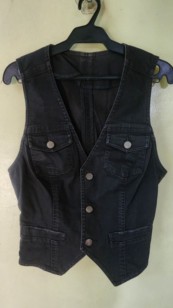 Black denim waistcoat vest with button pockets (Category: Coats, Jackets and Outerwear) located in Quezon City. Submitted by amenohana (Listing ID 1470357360, Image 2). Description: - Color: Dark grey or black - Material: Heavy cotton denim - Style: V-neck, sleeveless utility vest - Closures: Front metal buttons and snap-button chest pockets - Design: Structured paneled torso, perfect for layering - Adjustable.