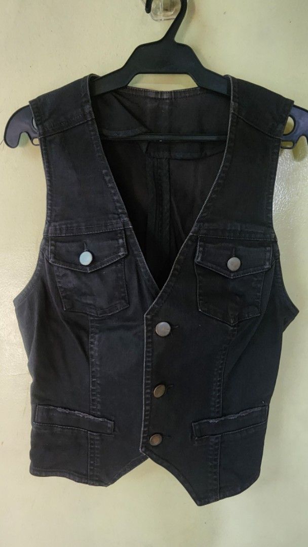Black denim waistcoat vest with button pockets (Category: Coats, Jackets and Outerwear) located in Quezon City. Submitted by amenohana (Listing ID 1470357360, Image 1). Description: - Color: Dark grey or black - Material: Heavy cotton denim - Style: V-neck, sleeveless utility vest - Closures: Front metal buttons and snap-button chest pockets - Design: Structured paneled torso, perfect for layering - Adjustable.
