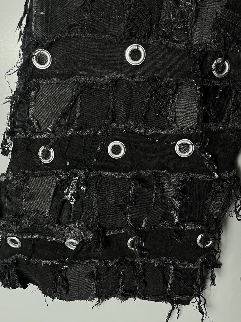 Black Distressed Patchwork Denim Shorts with Metal Eyelets (Category: Shorts) located in Dagupan City. Submitted by loves2thrifth (Listing ID 1470529327, Image 3). Description: - Style: Edgy streetwear black denim shorts - Details: Heavy patchwork, intentional distressing, and metal grommets throughout - Finish: Raw frayed edges and a dark faded wash - Fit: Drawstring waist with a branded button closure - Condition: Excellent unique piece, grab t