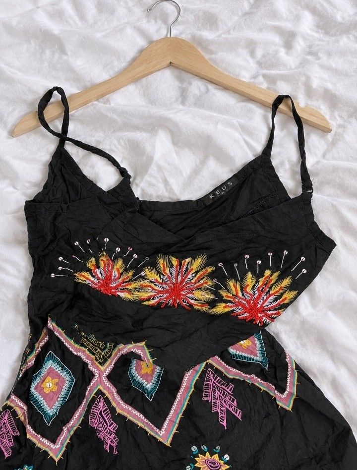 Black Embroidered Boho Cami Top💓🪽 (Category: Others Tops) located in Batangas. Submitted by itgirl.archive (Listing ID 1470373085, Image 2). Description: - Brand: K.E.U.S. (as shown on the tag) - Size: Medium (can fit Small as well) - Color: Black with multicolor embroidery - Material: Lightweight-looking fabric with a crinkled texture - Design: Adjustable spaghetti straps, V-neckline, vibrant floral embroidery, and geometric patterns - Hem: Bl