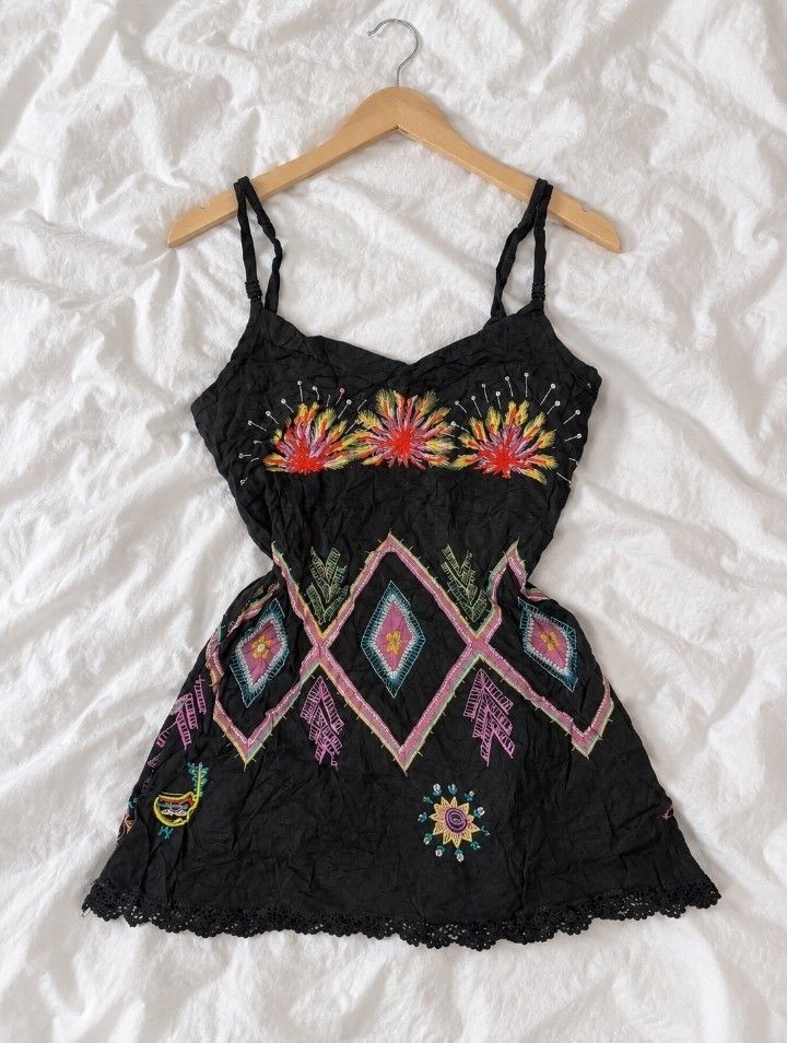 Black Embroidered Boho Cami Top💓🪽 (Category: Others Tops) located in Batangas. Submitted by itgirl.archive (Listing ID 1470373085, Image 1). Description: - Brand: K.E.U.S. (as shown on the tag) - Size: Medium (can fit Small as well) - Color: Black with multicolor embroidery - Material: Lightweight-looking fabric with a crinkled texture - Design: Adjustable spaghetti straps, V-neckline, vibrant floral embroidery, and geometric patterns - Hem: Bl