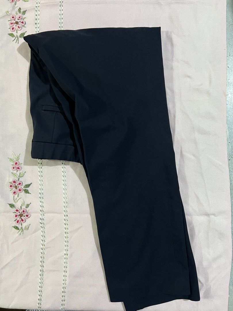 Black Formal Trousers Office Pants (Category: Other Bottoms) located in Marikina City. Submitted by tintinarenas (Listing ID 1470463807, Image 1). Description: - Color: Solid black - Fit: Classic slim cut with clean lines - Rise: Mid-rise waist with pleated front detail - Pockets: Back welt pockets - Material: Smooth polyester blend - Closure: Standard button and zip - Condition: Clean, great staple piece for work or smart casual wear.