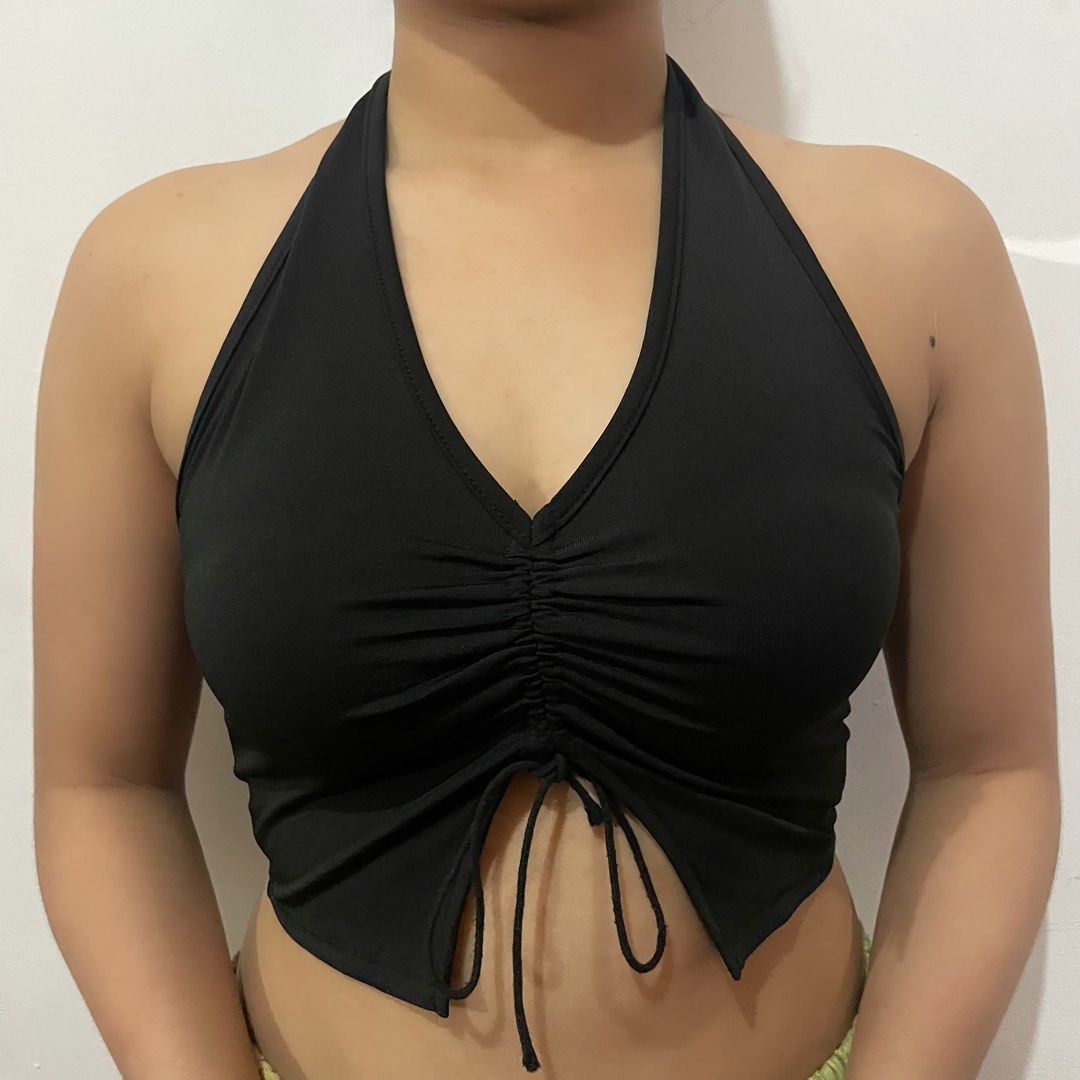 Black Halter Top Ruched Front Crop Top (Category: Sleeveless) located in Iligan City. Submitted by lisiantbel (Listing ID 1470527865, Image 2). Description: - Color: Black - Style: Halter neck crop top - Details: Ruched center with adjustable drawstrings at the hem - Design: Trendy split front hem - Fabric: Stretchy, comfortable material - Versatility: Easy to match with high-waisted jeans or skirts; great for casual wear or going out.
