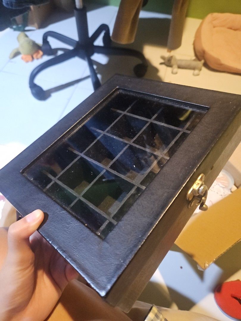 Black Jewelry box (Category: Accessory Holder, Box & Organizers) located in Manila. Submitted by elliaaa_ (Listing ID 1470463797, Image 1). Description: - Color: Sleek black storage box - Design: Features multiple compartments and a clear glass window top - Security: Equipped with a reliable metal latch on the front - Ideal For: Organizing small accessories, trinkets, or valuable collectibles - RFS: Decluttering.