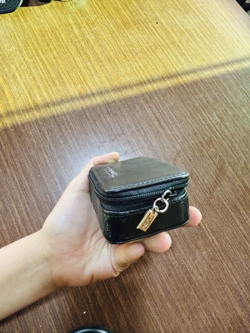 Black Leatherette Zip Pouch With Mirror (Category: Purses & Pouches) located in Manila. Submitted by starbalesukandjapansurplus (Listing ID 1470555507, Image 2). Description: - Color: Classic Black - Closure: Secure zip closure with a stylish front metal accent - Features: Built-in mirror on the upper inner lid - Interior: Clean, black fabric-lined compartment - Size: Compact and handy, fits easily in your bag or hand - Condition: Excellent / Rea