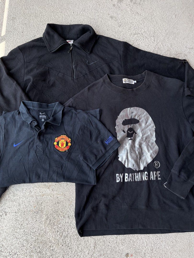 Black Nike & A Bathing Ape Clothing Bundle (Category: Activewear) located in Manila. Submitted by tyron.dragon (Listing ID 1470421974, Image 1). Description: - Lot of 3 versatile black tops for casual wear and sports - Nike quarter-zip fleece jacket - Manchester United Nike polo shirt (Tag size M) - Bathing Ape (Bape) crewneck sweatshirt featuring a large ape head graphic - All items in a matching dark black colorway - Great value bundle for stre