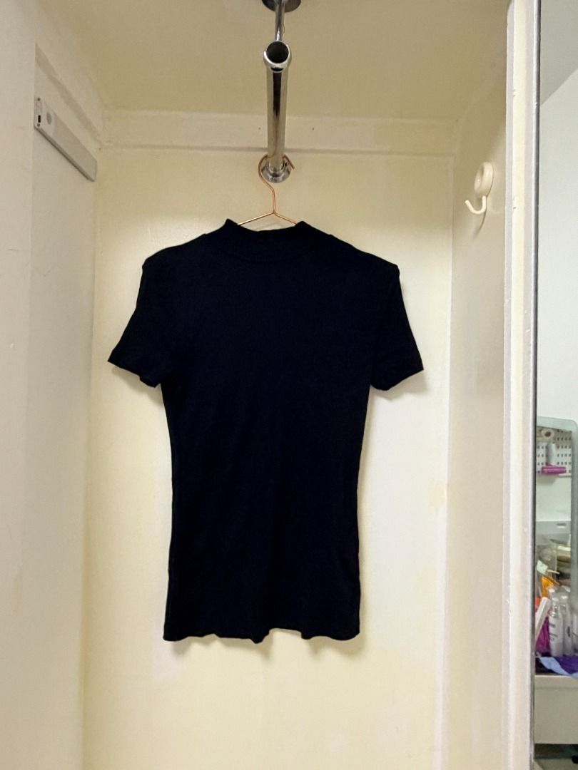 Black ribbed short sleeve mock neck top (Category: Sleeveless) located in Makati City. Submitted by yuriandcole (Listing ID 1470383881, Image 1). Description: - Color: Solid black - Material: Stretchy ribbed knit - Design: Short sleeves with a mock neckline - Fit: Slim silhouette, hits around the hip - Condition: Clean, no stains or damage visible - Style: Versatile basic piece, easy to match with jeans or skirts.